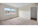 This bedroom has neutral carpet and a large window at 395 Raspberry Ln, Monument, CO 80132