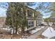 Two-story home with light yellow siding, dark shutters, and well-maintained landscaping at 395 Raspberry Ln, Monument, CO 80132