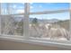 This bedroom window has a view of trees and mountains at 395 Raspberry Ln, Monument, CO 80132