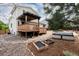 Exterior view showcasing a wood deck and outdoor garden with garden beds and gravel ground at 8129 Locust Dr, Littleton, CO 80125