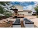 Gravel backyard featuring two metal garden beds with room for gardening with a wooden deck at 8129 Locust Dr, Littleton, CO 80125