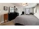 Comfortable bedroom with plush carpeting, ceiling fan, and windows providing ample natural light at 8129 Locust Dr, Littleton, CO 80125