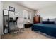 Cozy bedroom with functional workspace, comfy seating, and well lit window at 8129 Locust Dr, Littleton, CO 80125