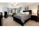 Comfortable bedroom with plush carpeting, ceiling fan, and windows providing ample natural light at 8129 Locust Dr, Littleton, CO 80125
