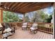 Cozy deck featuring a wooden pergola, overhead lighting and comfortable seating for outdoor relaxation at 8129 Locust Dr, Littleton, CO 80125