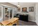 Bright dining area featuring a sliding glass door to the deck, wood floors, and stylish decor at 8129 Locust Dr, Littleton, CO 80125