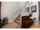 Warm entryway with neutral tones, a carpeted staircase, and decorative accents at 8129 Locust Dr, Littleton, CO 80125