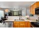 Galley-style kitchen with light countertops open to the dining and living area at 8129 Locust Dr, Littleton, CO 80125