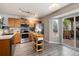 Traditional kitchen featuring stainless steel appliances, light wood cabinets, and access to an outdoor deck at 8129 Locust Dr, Littleton, CO 80125