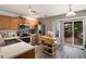Traditional kitchen featuring stainless steel appliances, light wood cabinets, and access to an outdoor deck at 8129 Locust Dr, Littleton, CO 80125