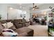 Open concept living space featuring a large sectional sofa and a staircase at 8129 Locust Dr, Littleton, CO 80125