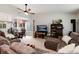 Spacious living room open to the dining area, featuring large windows at 8129 Locust Dr, Littleton, CO 80125