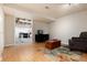Relaxing living room featuring wood flooring, couch, shelving, tv and large rug at 8129 Locust Dr, Littleton, CO 80125
