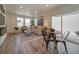 Bright living room with wood floors, comfy sofa, and a modern fireplace at 10317 Vaughn Way, Commerce City, CO 80022