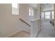 Upstairs hallway with carpeted flooring and access to bedrooms at 10317 Vaughn Way, Commerce City, CO 80022