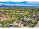 Breathtaking aerial view of a community with lush greenery, homes and a scenic mountain backdrop at 5305 W Lake Pl, Littleton, CO 80123