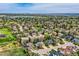 Gorgeous aerial view of a community nestled among lush greenery and trees with skyline backdrop at 5305 W Lake Pl, Littleton, CO 80123