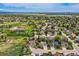 Expansive aerial view showcasing the community, with lush greenery, surrounding lakes and various home styles at 5305 W Lake Pl, Littleton, CO 80123