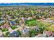 An aerial view of a charming neighborhood with lush green lawns, mature trees, and well-kept homes at 5305 W Lake Pl, Littleton, CO 80123
