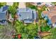 Aerial of backyard featuring mature trees, green grass, patio, trampoline and playground at 5305 W Lake Pl, Littleton, CO 80123