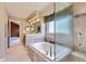 Elegant bathroom featuring a soaking tub with a shower glass and stylish tile surround, creating a spa-like retreat at 5305 W Lake Pl, Littleton, CO 80123