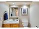 Bathroom with a single vanity, large mirror, and a toilet at 5305 W Lake Pl, Littleton, CO 80123