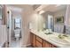 Bright bathroom featuring a dual sink vanity and a separate toilet room, for added privacy and convenience at 5305 W Lake Pl, Littleton, CO 80123