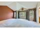 Large bedroom with vaulted ceilings, neutral carpet, and many windows with backyard views at 5305 W Lake Pl, Littleton, CO 80123