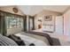 Bedroom with neutral walls, carpet, large windows, and stylish white cabinets at 5305 W Lake Pl, Littleton, CO 80123