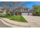 Beautiful brick home with a lush green lawn and a spacious two-car garage at 5305 W Lake Pl, Littleton, CO 80123