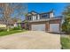 Lovely two-story brick home featuring an attached two-car garage and a wide driveway at 5305 W Lake Pl, Littleton, CO 80123