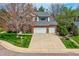 Charming two-story brick home with a well-manicured lawn and a two-car garage at 5305 W Lake Pl, Littleton, CO 80123
