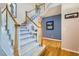 Elegant foyer with hardwood floors, staircase, and tasteful decor at 5305 W Lake Pl, Littleton, CO 80123
