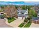Lovely home with brick accents, mature trees, a well-maintained lawn, and an attached two-car garage at 5305 W Lake Pl, Littleton, CO 80123