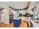 Bright kitchen featuring stainless steel appliances, blue island, and quartz countertops at 5305 W Lake Pl, Littleton, CO 80123