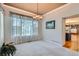 Bright living room with natural light, neutral carpet, and a decorative chandelier at 5305 W Lake Pl, Littleton, CO 80123