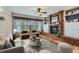 Cozy living room with a red brick fireplace, built-in shelves, and large windows for natural light at 5305 W Lake Pl, Littleton, CO 80123