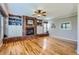 Cozy living room with a brick fireplace, built-in shelving, and hardwood floors at 5305 W Lake Pl, Littleton, CO 80123