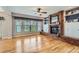 Spacious living room with a brick fireplace, built-in shelving, and large windows at 5305 W Lake Pl, Littleton, CO 80123