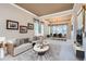 Inviting living room with neutral tones, modern furniture, and large windows provides ample natural light at 5305 W Lake Pl, Littleton, CO 80123