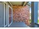 Welcoming front porch area featuring brick accents and a security door at 5305 W Lake Pl, Littleton, CO 80123