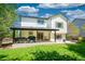 Spacious backyard featuring a well-maintained lawn and patio with outdoor furniture, perfect for outdoor living at 6488 Tilbury Ave, Firestone, CO 80504