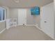 Finished basement area with a mounted TV and a play kitchen next to a window at 6488 Tilbury Ave, Firestone, CO 80504