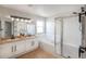 Bright bathroom features a double vanity, soaking tub, and glass-enclosed shower at 6488 Tilbury Ave, Firestone, CO 80504