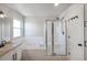 Clean bathroom with a shower, soaking tub and single vanity at 6488 Tilbury Ave, Firestone, CO 80504