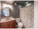 Cozy bathroom featuring a modern vanity, toilet, and a shower with a stylish shower curtain at 6488 Tilbury Ave, Firestone, CO 80504