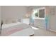 Bright bedroom features a large window with decorative pastel rainbow curtains and carpeted floor at 6488 Tilbury Ave, Firestone, CO 80504