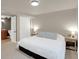 Bedroom with carpeted floors, an ensuite bathroom, and soft neutral colored walls at 6488 Tilbury Ave, Firestone, CO 80504