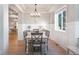 Elegant dining room featuring stylish furnishings, natural light, and modern light fixture for gatherings at 6488 Tilbury Ave, Firestone, CO 80504