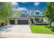 Charming two-story home featuring a manicured lawn, stone accents, and a spacious three-car garage at 6488 Tilbury Ave, Firestone, CO 80504